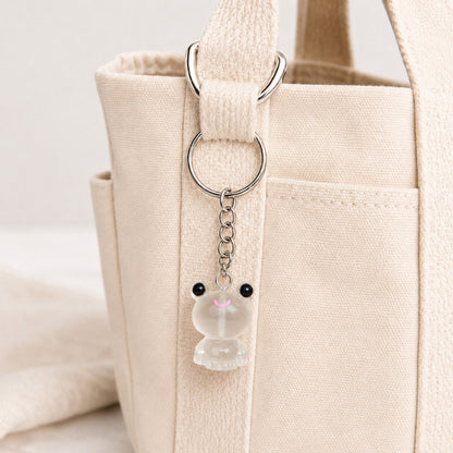 Frosted Frog in White Keyring & Bag Charm attached to a cream canvas bag