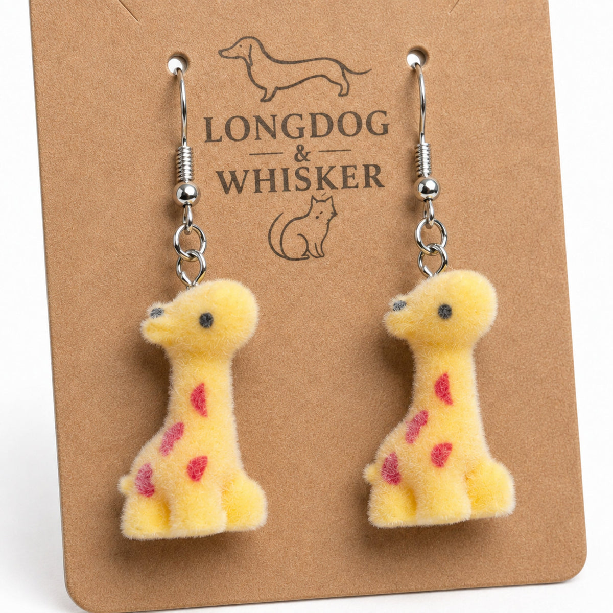 Close-up of fuzzy giraffe drop earrings with silver-tone hooks