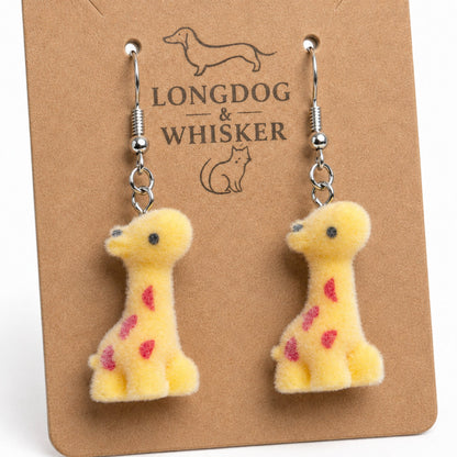 Close-up of fuzzy giraffe drop earrings with silver-tone hooks