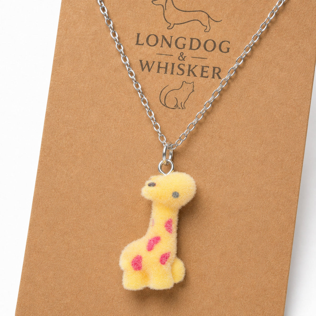 Close-up of the fuzzy giraffe charm on a silver-tone necklace chain