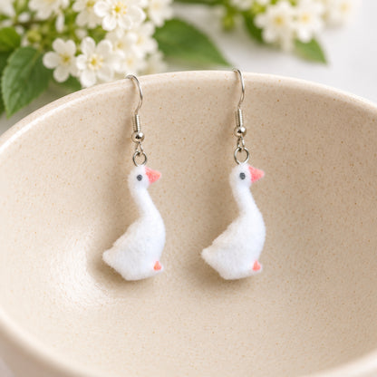 Fuzzy Goose Earrings displayed in a ceramic bowl