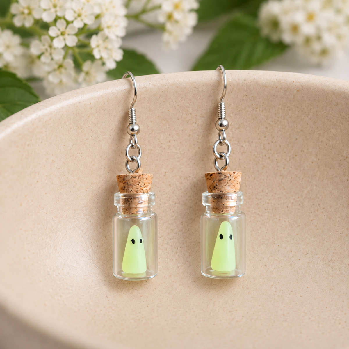 Ghost in a Bottle Earrings arranged in a ceramic bowl