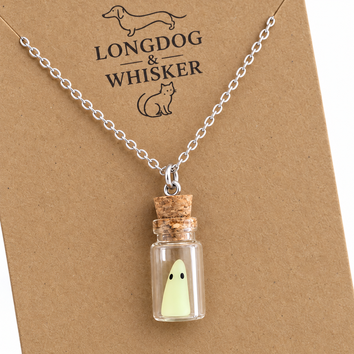 Close-up of the pale-green ghost, glass bottle, cork and silver-tone necklace connectors