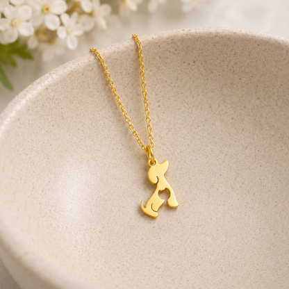 Cat At Heart Dog Necklace - Gold displayed in a lifestyle product photo