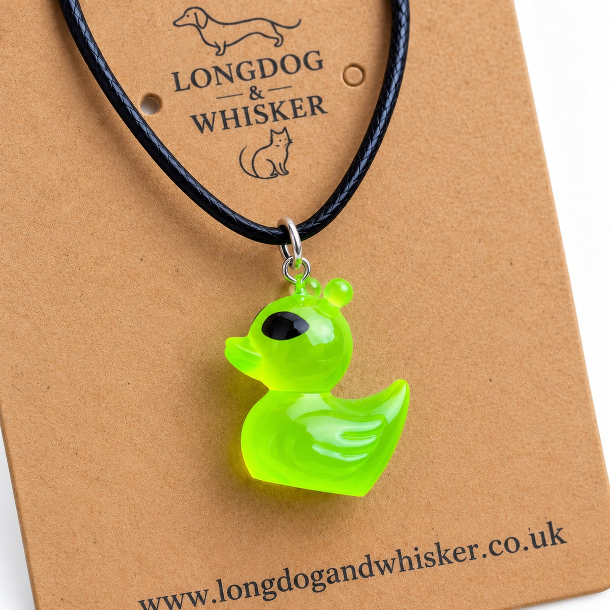 Close-up of the green alien duck charm, black cord and silver-tone connecting hardware