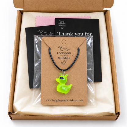 Green alien duck black cord necklace presented on its card in gift-ready packaging