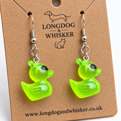 Close-up of the translucent lime-green alien duck charms, antennae and silver-tone hooks
