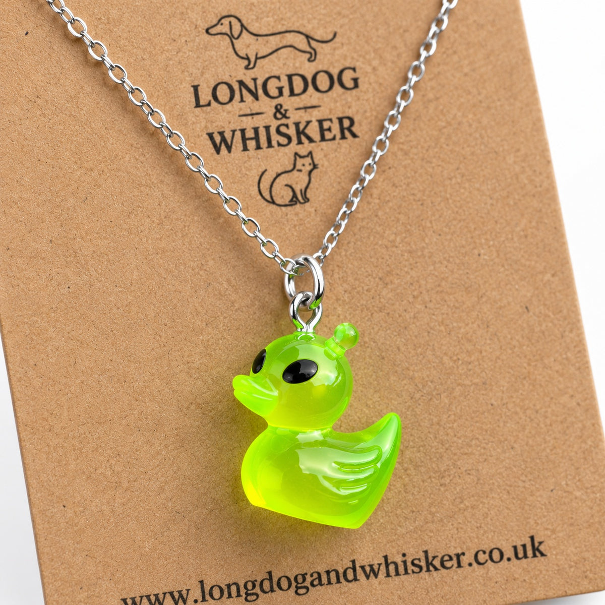 Close-up of the green alien duck charm and silver-tone necklace connector