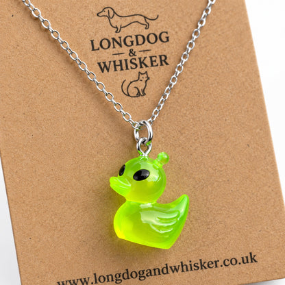 Close-up of the green alien duck charm and silver-tone necklace connector