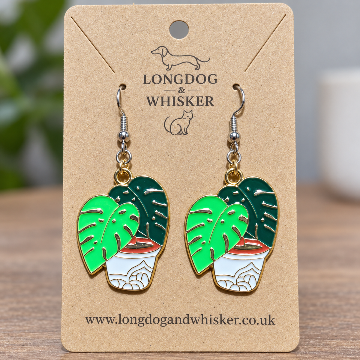 Close-up of Green Monstera Earrings with silver hooks and gold connector rings