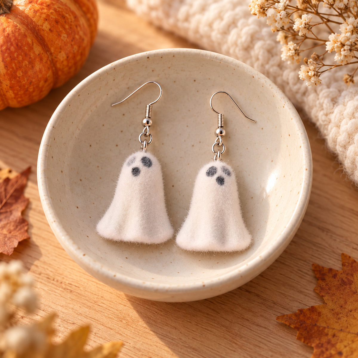 Happy Ghost Earrings in a cream ceramic bowl