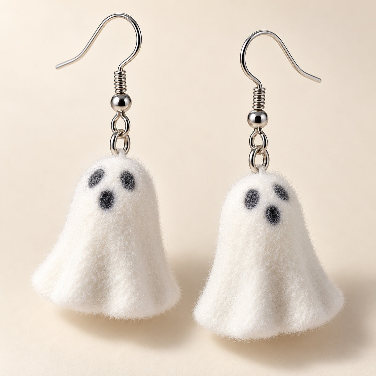 Close-up of Happy Ghost Earrings charm and silver hooks