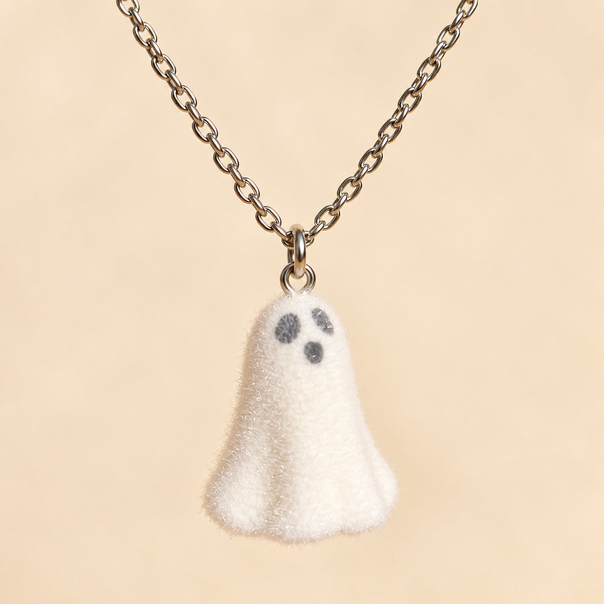Close-up of Happy Ghost Necklace charm and silver chain