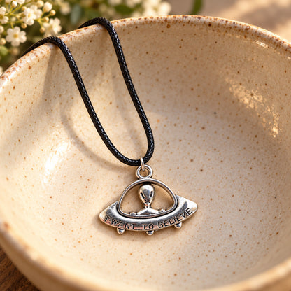 I Want to Believe UFO necklace in ceramic bowl lifestyle scene