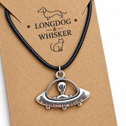 Close-up of I Want to Believe UFO pendant necklace