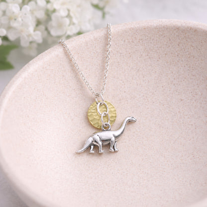 Silver Brontosaurus Dinosaur Necklace displayed in a lifestyle product photo