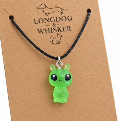 Close-up of the Little Green Alien Black Cord Necklace pendant