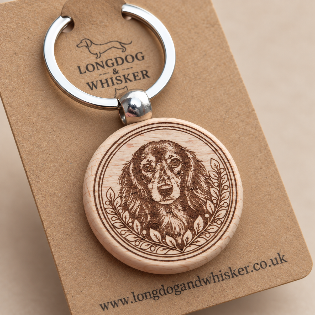Close-up of long-haired Dachshund portrait, leafy border, wood edge and silver connector