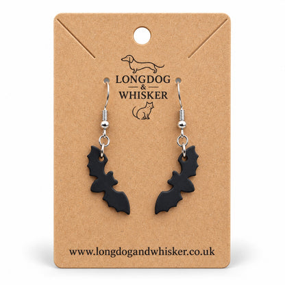Matte black bat silhouette drop earrings on a Longdog & Whisker kraft card