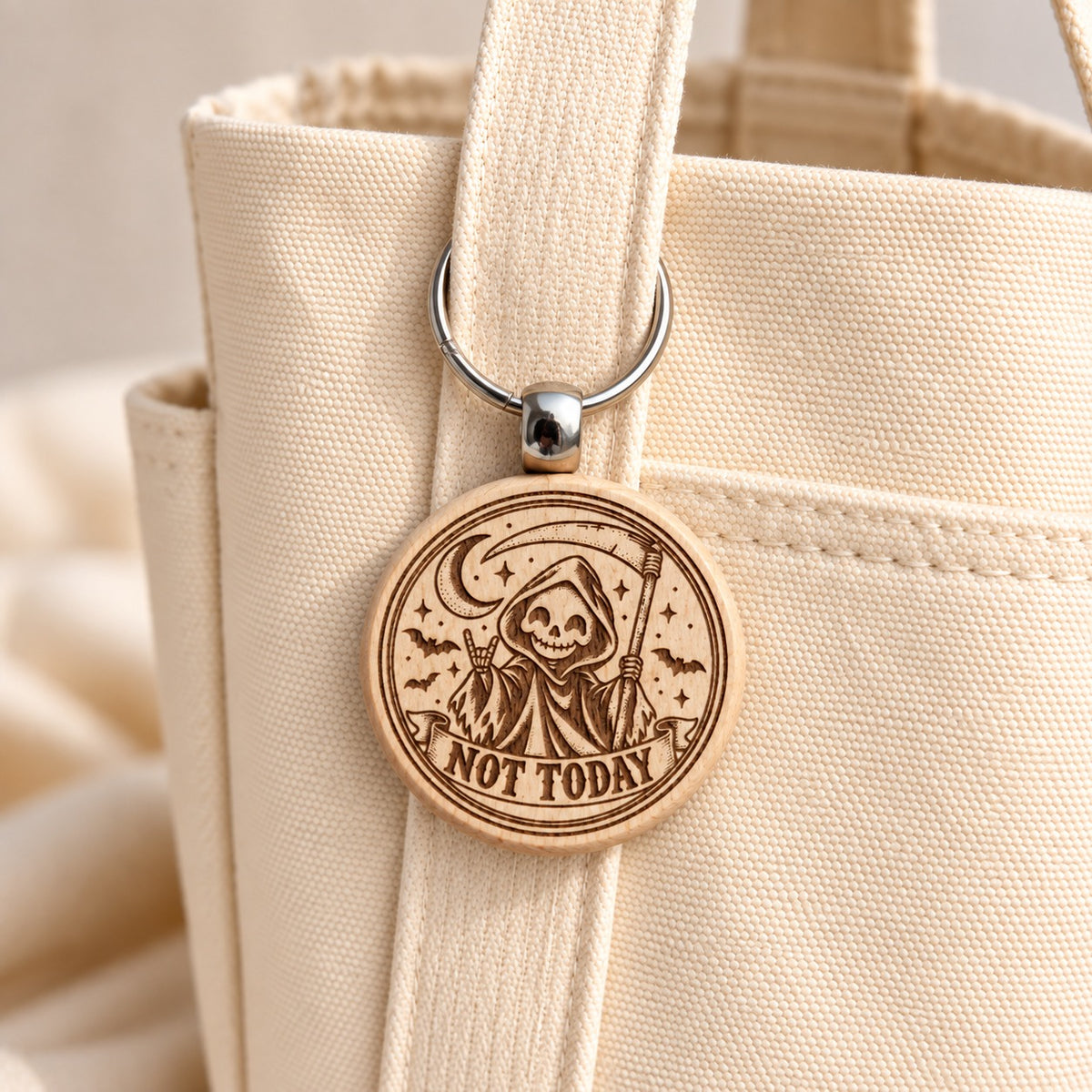 Not Today grim reaper wooden keyring attached to a cream canvas tote
