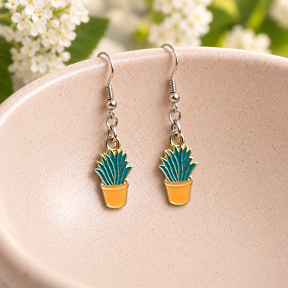 Orange Succulent Earrings with silver-tone hooks on a blush speckled bowl