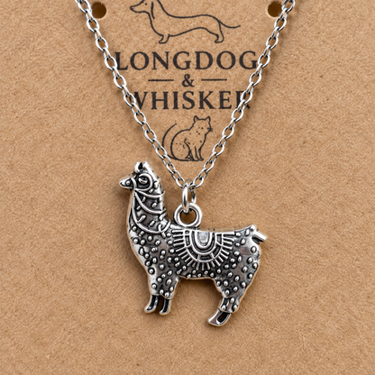Close-up of ornate silver-tone llama pendant necklace