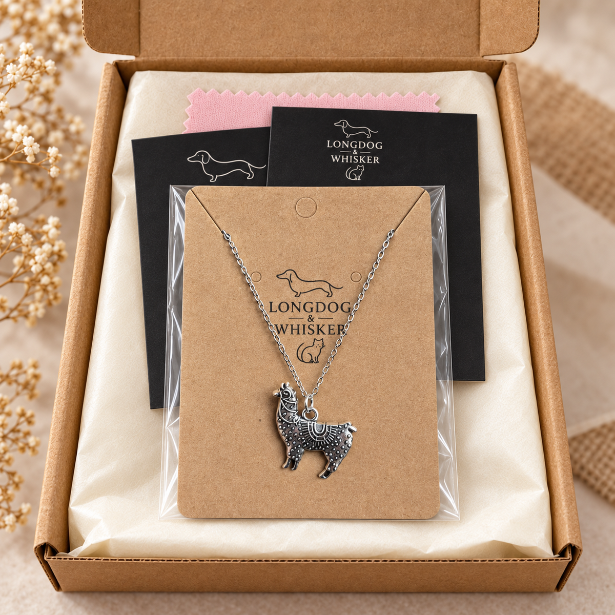 Ornate silver-tone llama pendant necklace in Longdog & Whisker gift packaging