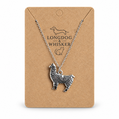 Ornate silver-tone llama pendant necklace on Longdog & Whisker display card