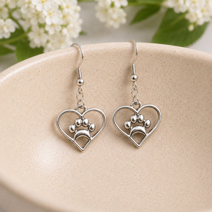 Silver Heart Dog Paw Print Earrings displayed in a lifestyle product photo