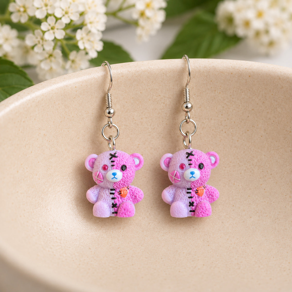 Pink Pastel Stitched Zombie Bear Earrings in ceramic bowl lifestyle scene