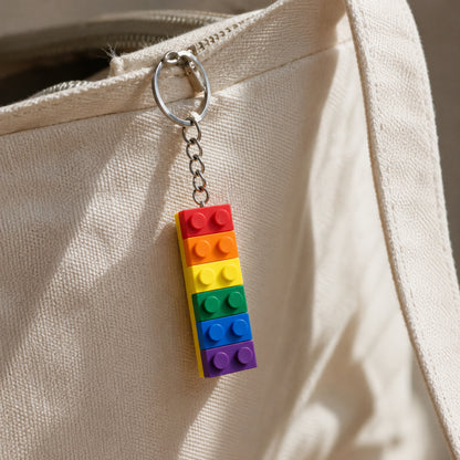 Pride Brick Keyring - Red to Purple shown as a bag charm