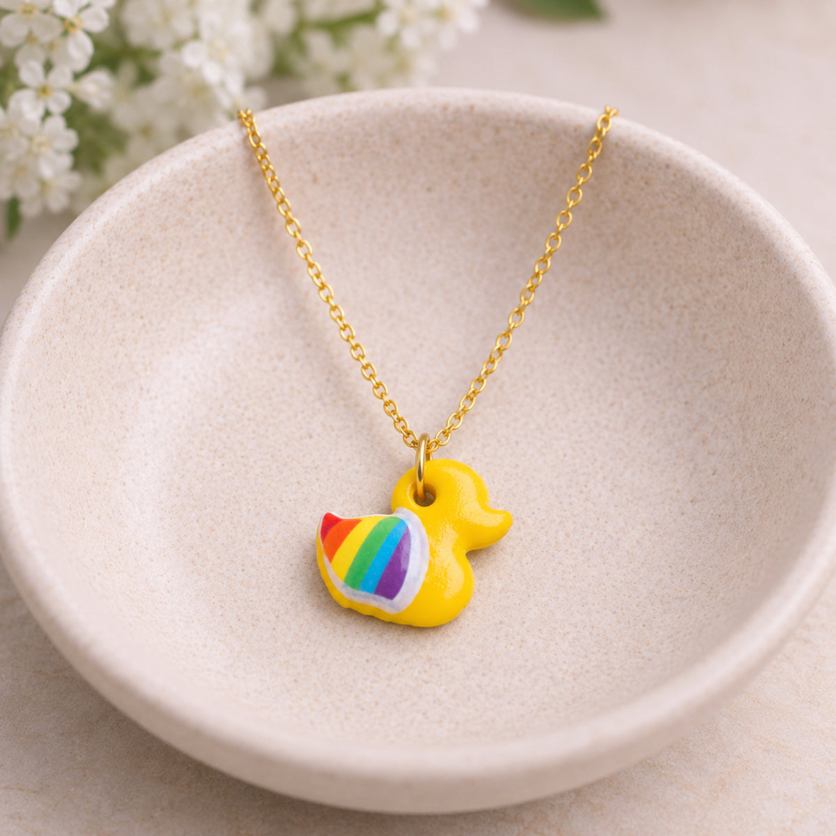 Pride Ducky Necklace Gold Chain displayed in a lifestyle product photo