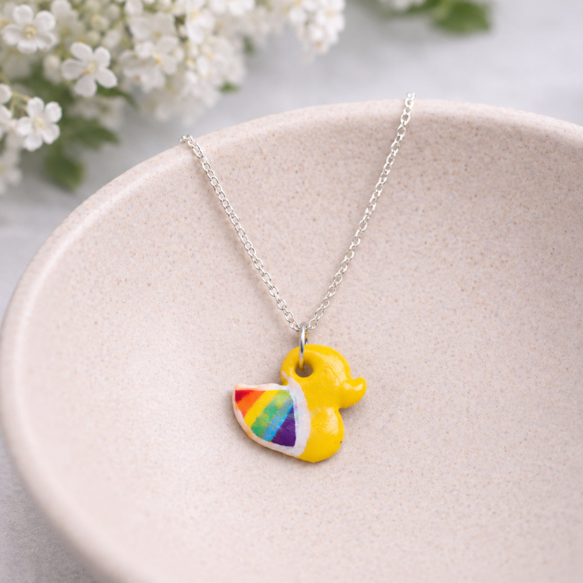 Pride Ducky Necklace Silver Chain displayed in a lifestyle product photo