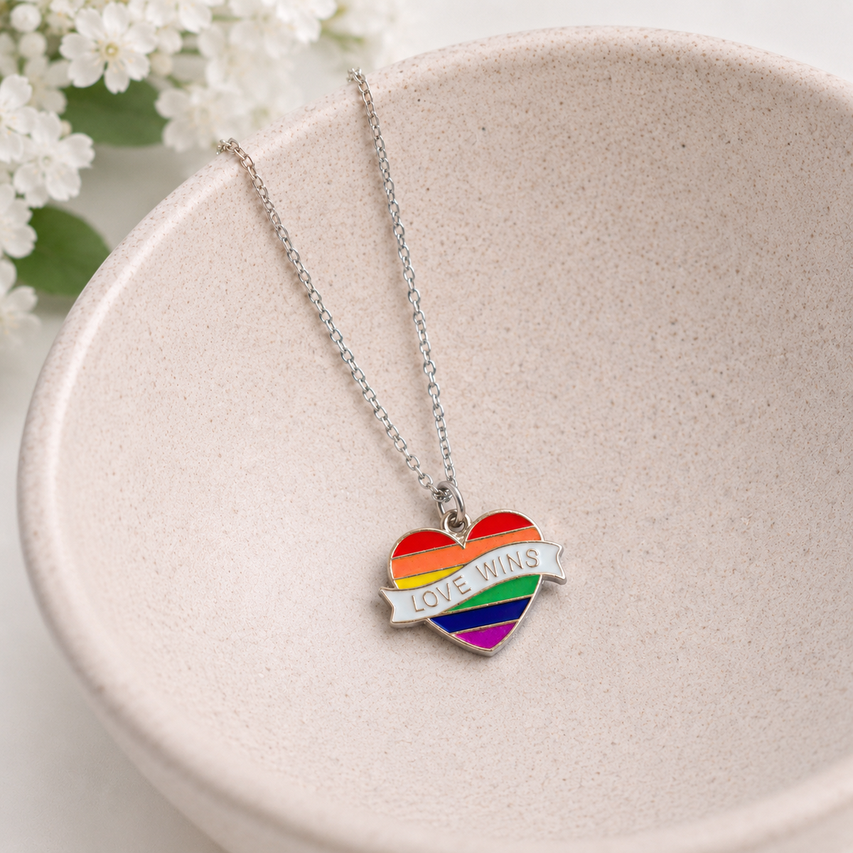 Pride Rainbow Love Wins Banner Heart Necklace Silver Chain displayed in a lifestyle product photo