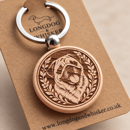 Close-up of the engraved Pug wooden keyring and silver-tone hardware