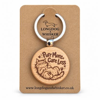 Purr More Care Less wooden keyring with lounging cat on Longdog & Whisker card
