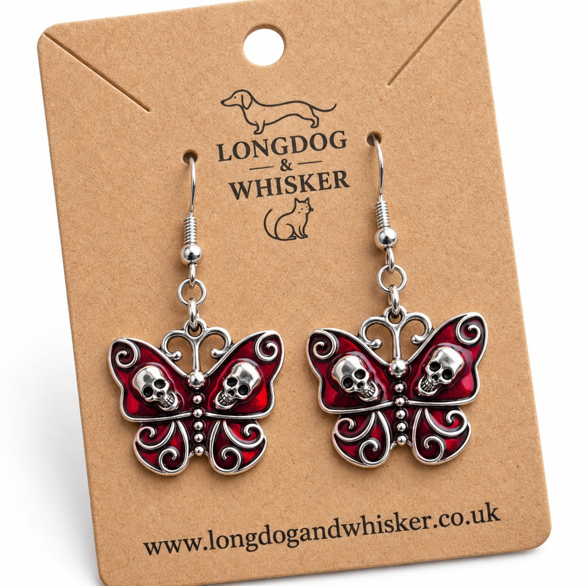 Close-up of red skull butterfly earrings showing deeper crimson wings and raised silver-tone skull details