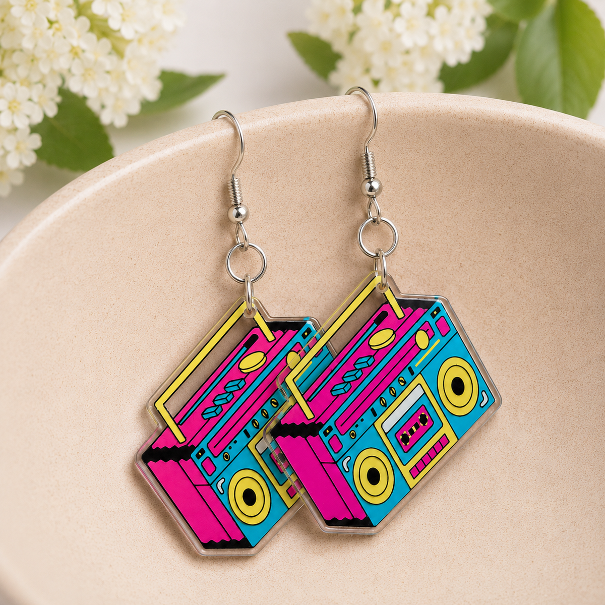 Retro Boombox Earrings hanging from a ceramic bowl