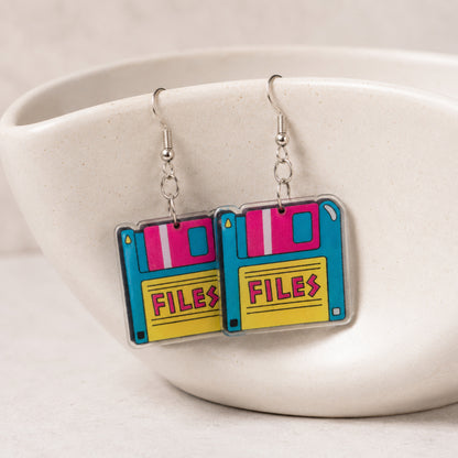 Retro Floppy Disk Earrings hanging from a ceramic bowl