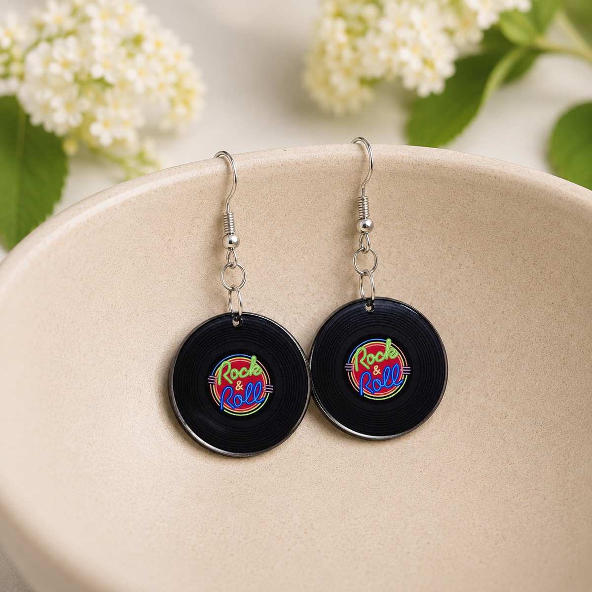 Retro Rock & Roll Vinyl Record Earrings hanging inside a ceramic bowl