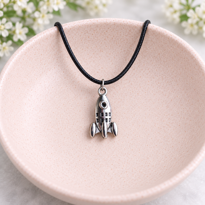 Silver Rocket Necklace on Black Cord in a blush bowl lifestyle photo