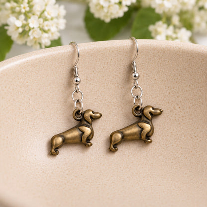 Sausage Dog Earrings - Bronze displayed in a lifestyle product photo