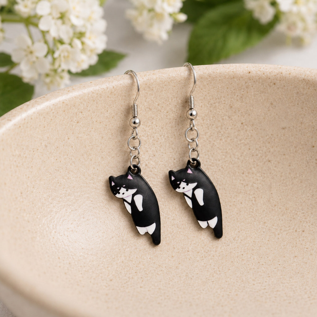Scruffles Cat Earrings - Black & White displayed in a lifestyle product photo