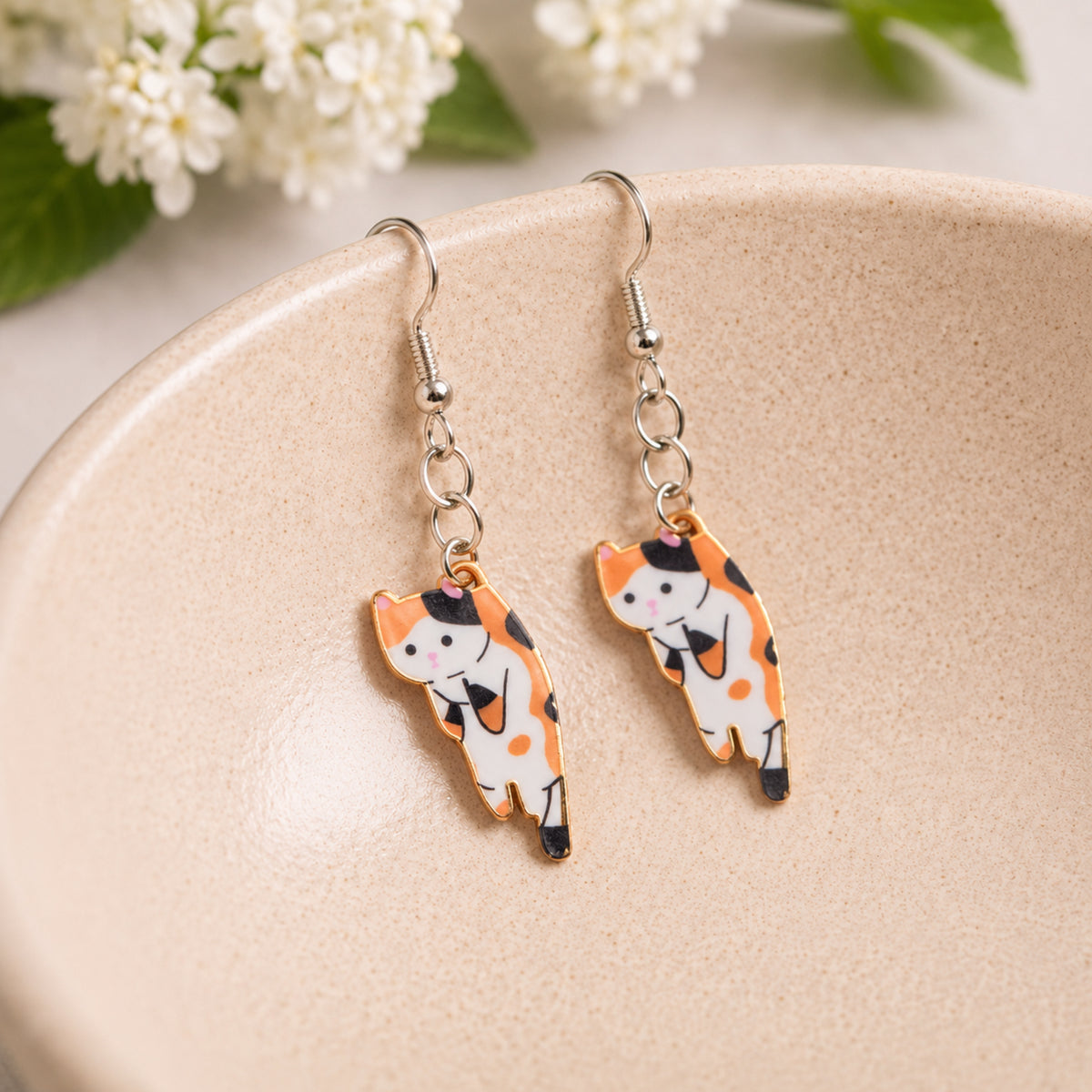 Scruffles Cat Earrings - Calico displayed in a lifestyle product photo
