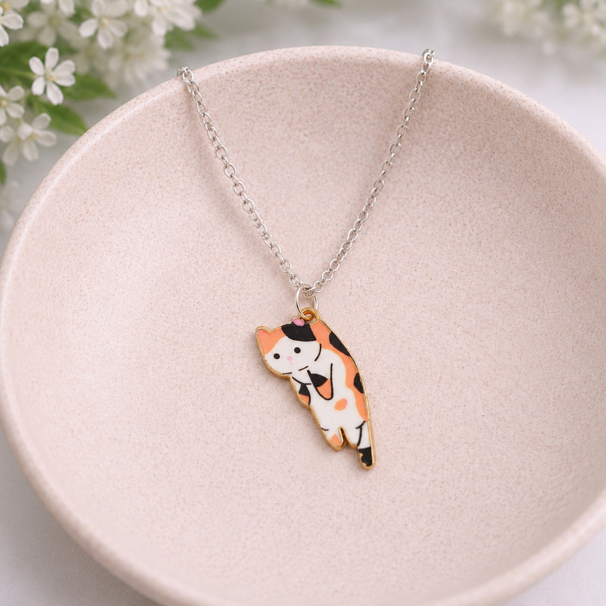 Scruffles Cat Necklace - Calico displayed in a lifestyle product photo