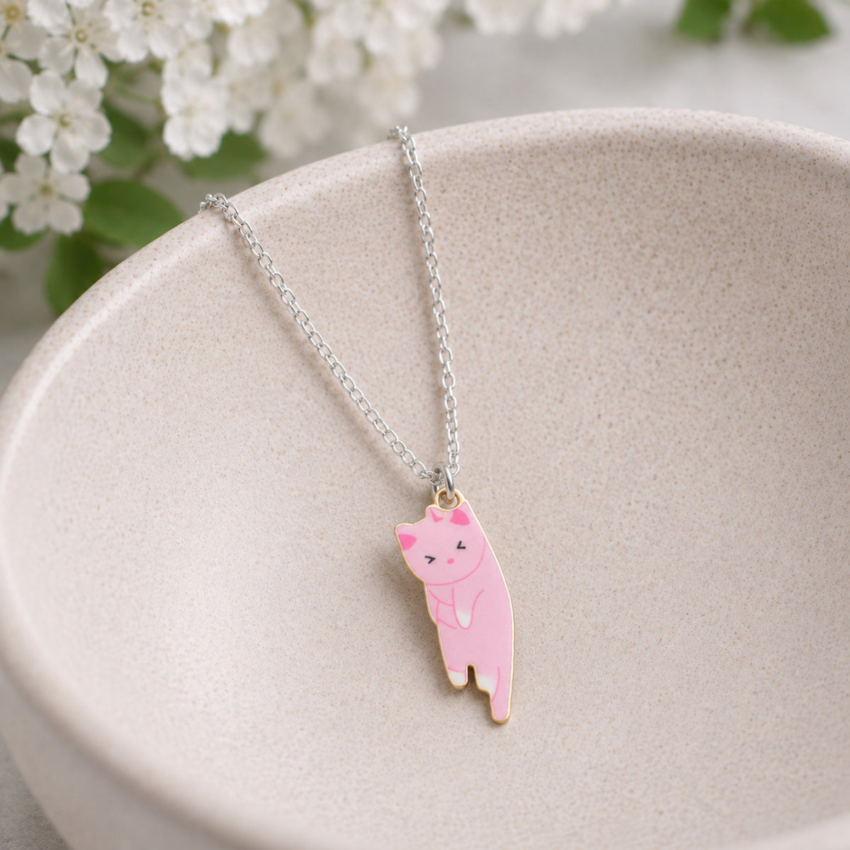 Scruffles Cat Necklace - Pink displayed in a lifestyle product photo