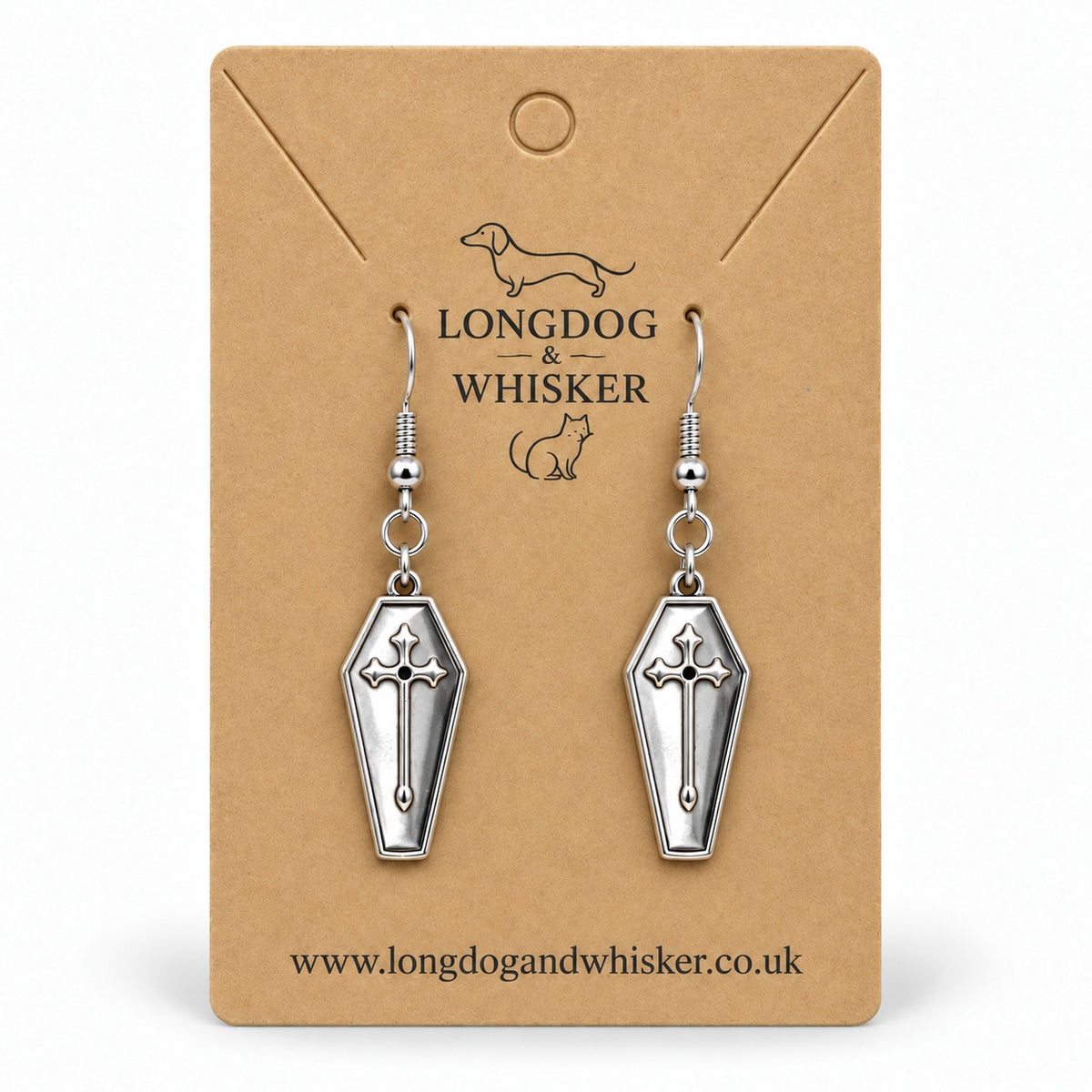 Silver coffin cross drop earrings on a Longdog & Whisker kraft card.