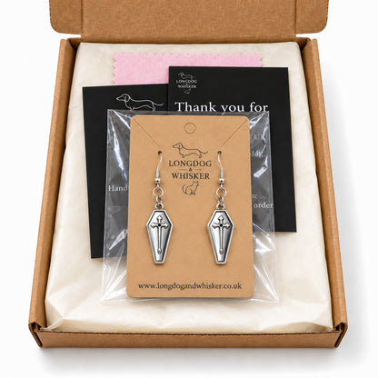 Silver coffin cross drop earrings in Longdog & Whisker postal packaging.
