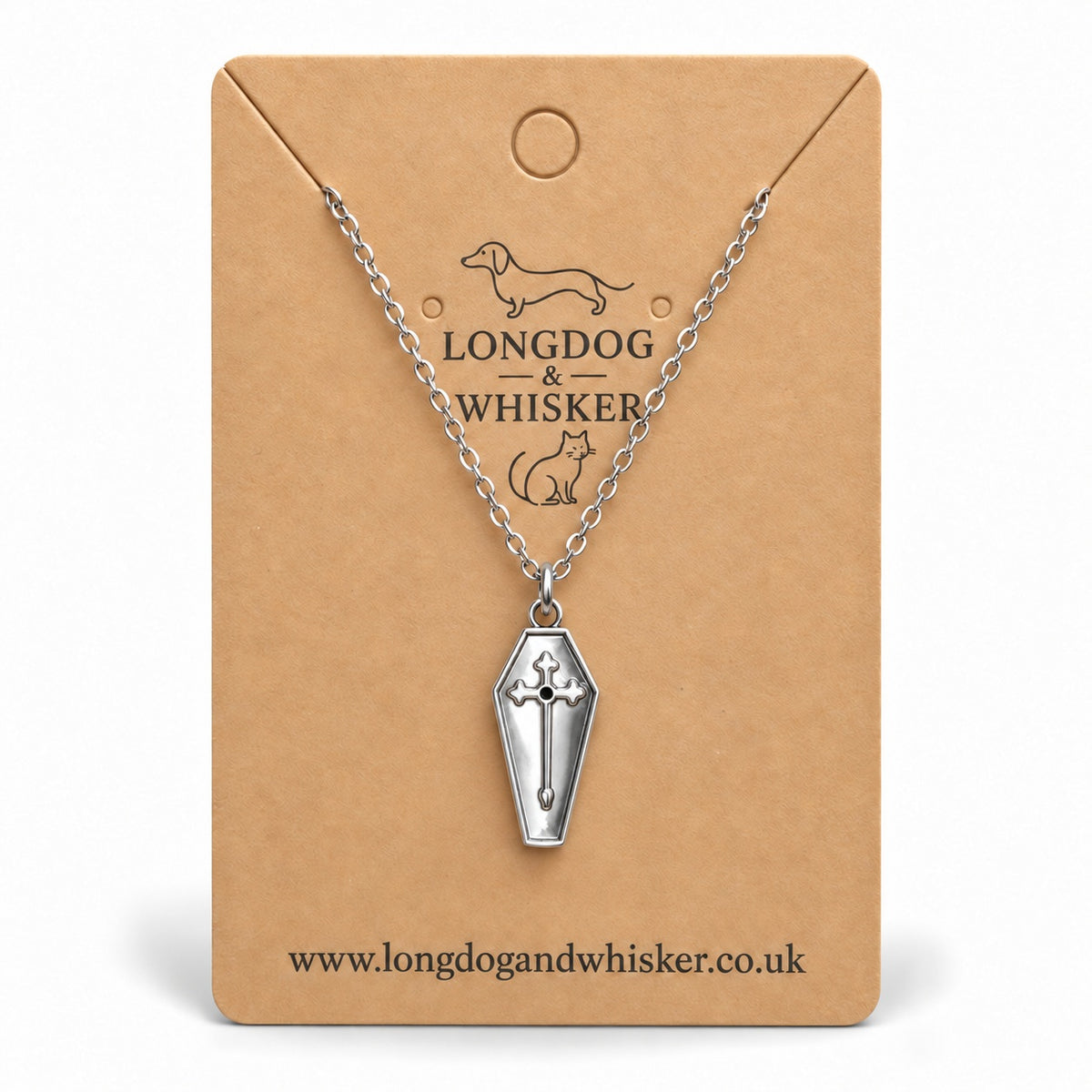 Silver coffin cross necklace on a Longdog & Whisker kraft card.