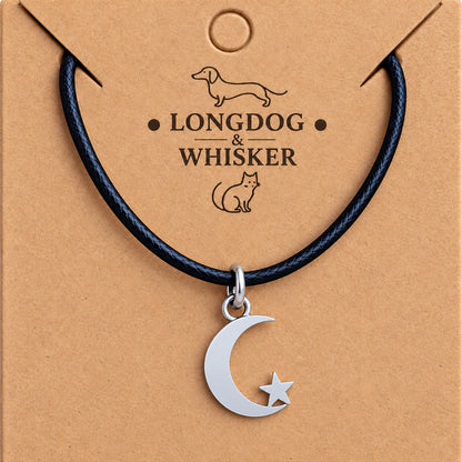 Close-up of the silver-tone moon, fixed star and black cord connectors